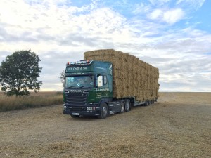 Straw bales loaded on to a transporter for haulage